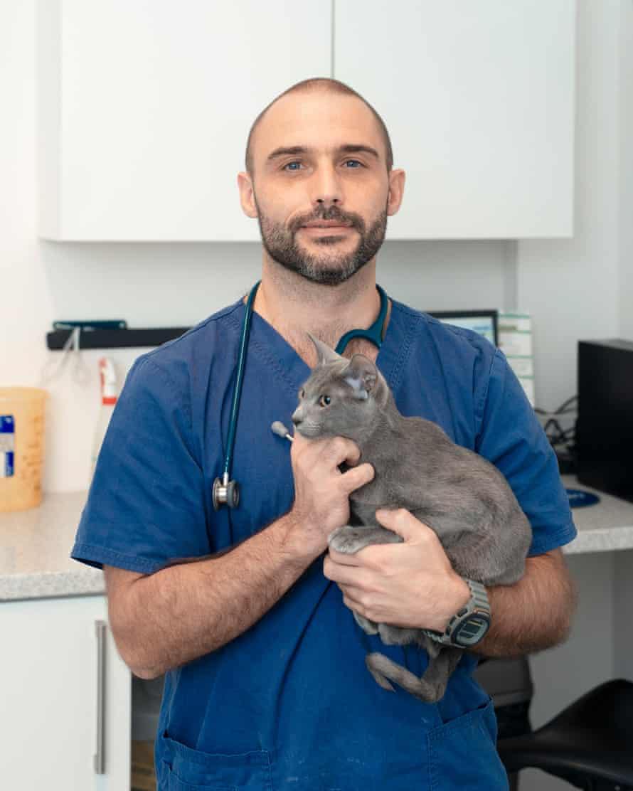 ‘The average UK vet sees a new animal with a new problem every 10 minutes’: Gareth Steele with Mali the cat, photographed at his practice in Neath, South Wales.