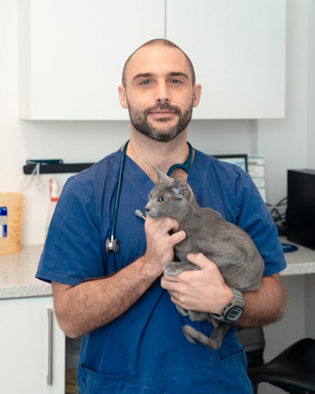 ‘The average UK vet sees a new animal with a new problem every 10 minutes’: Gareth Steele with Mali the cat, photographed at his practice in Neath, South Wales.