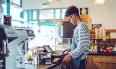 Young barista is working in a café