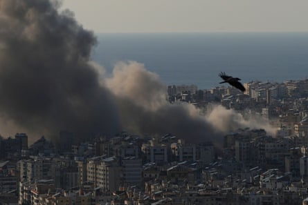 Smoke over high-rise buildings in an aerial photo.
