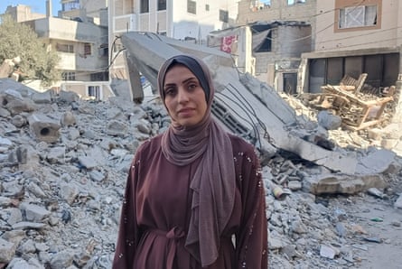 Hadeel Shahiber standing in front of grey rubble