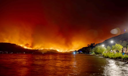 Residents watch the McDougall Creek wildfire in West Kelowna, British Columbia, Canada, on 17 August 2023, from Kelowna