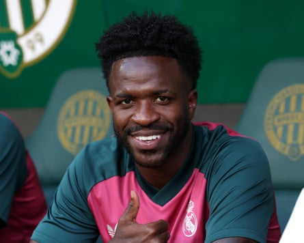 The Real Madrid forward Vinícius Junior smiles and gives a thumbs up to the camera before his team’s pre-season friendly against Ferencvaros in Budapest.