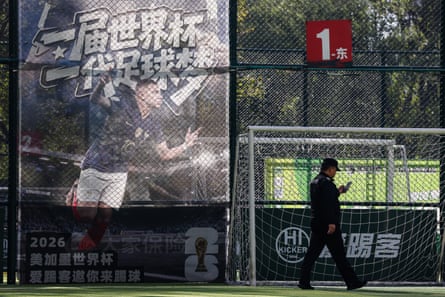 An image of Kylian Mbappé towers over a football pitch in Beijing.