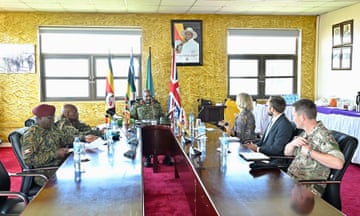 African army officers sit across a table from a European officials and an officer