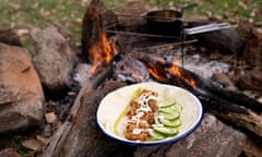Fish wraps with oyster sauce and panko batter on a plate in front of a campfire