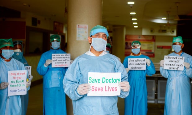 Doctors and medical staff at Narayan Swaroop Hospital in Allahabad, India, protest against assaults on medical staff