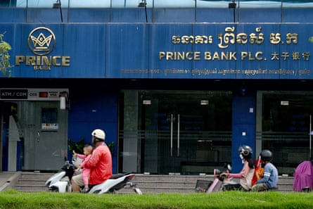 Motorists ride past a branch of the Prince Bank in Phnom Penh on 15 October 2025.