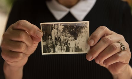 A Palestinian woman holds a photo of her family in 1956 after they moved into their home in the Sheikh Jarrah neighbourhood of east Jerusalem.