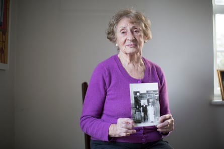 Susan Pollack, who the survived Bergen-Belsen camp, holds a photograph of herself with her parents, who both perished at the hands of the Nazis.