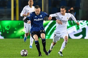Atalanta’s Josip Ilicic holds off Lucas Vazquez.
