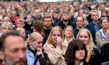 Thousands turn out in Copenhagen to mourn the death of three people in a shopping centre mass shooting.