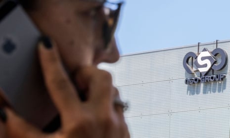 A woman uses her phone in front of the building housing the Israeli NSO group, in Herzliya, near Tel Aviv