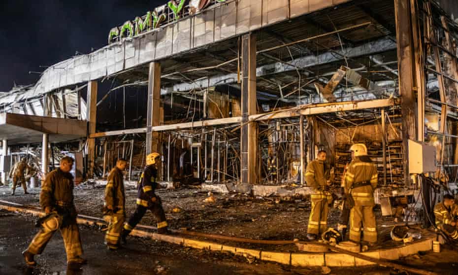 firefighters at the site of a Russian missile strike on a shopping centre in Kremenchuk, central Ukraine.