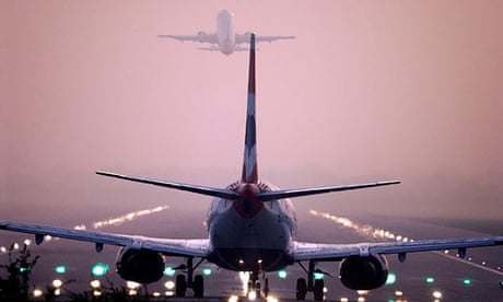 Rear view as two jet planes follow each other almost nose to tail on take off from Gatwick airport.