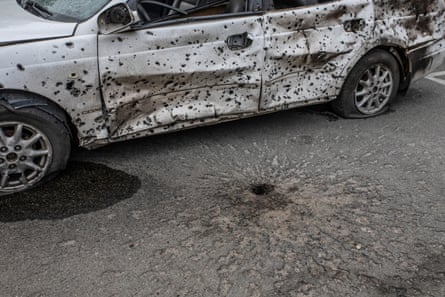 A car in Irpin showing the characteristic holes caused by submunitions from cluster bombs used by the Russian military