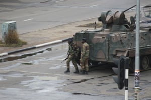 A military tank is seen with armed soldiers on the road leading to President Robert Mugabe’s office in Harare, Zimbabwe Wednesday, Nov. 15, 2017. Overnight, at least three explosions were heard in the capital, Harare, and military vehicles were seen in the streets. On Monday, the army commander had threatened to “step in” to calm political tensions over the 93-year-old Mugabe’s possible successor. (AP Photo/Tsvangirayi Mukwazhi)