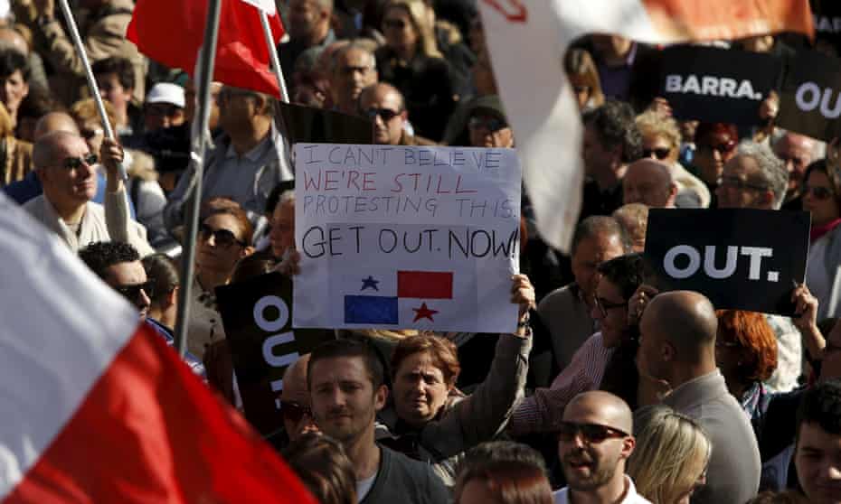 Protesters take part in a demonstration calling on Maltese Prime Minister Joseph Muscat to resign