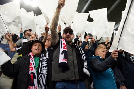 Fans of Newcastle United look on as they wave a flag prior to the UEFA Champions League match between Newcastle United FC and Paris Saint-Germain at St. James Park.