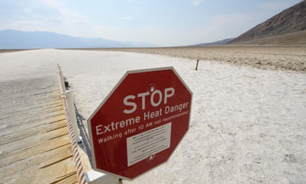 A sign warns of extreme heat danger at the salt flats in Death Valley national park.