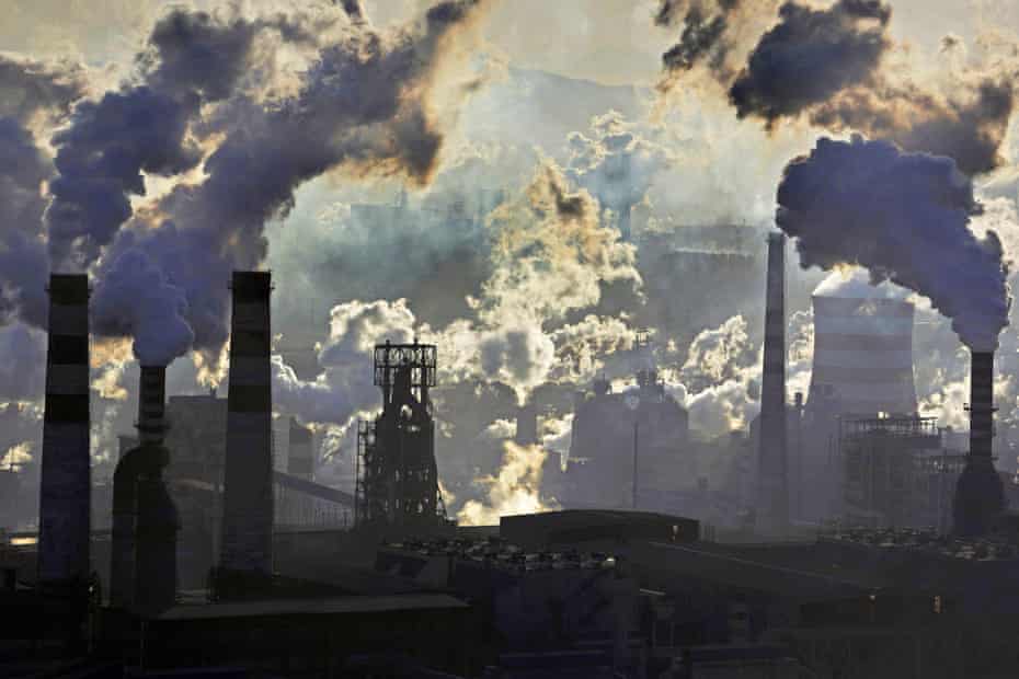 This handout photo taken on November 17, 2014 and released by Greenpeace on January 22, 2015 shows smoke billowing from smokestacks from iron and steel plants in Qian'an, Hebei province.  The skies of China's notoriously smog-filled cities saw a marginal amelioration in 2014, according to figures released by Greenpeace on January 22, 2015, but pollution remained far above national and international standards.
