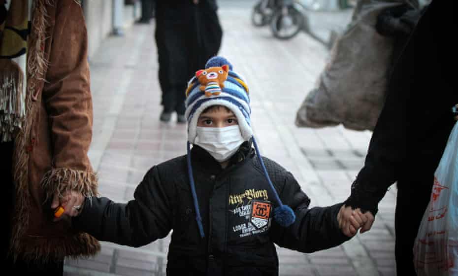 A boy wears a mask against air pollution on a street in Tehran on 20 December.
