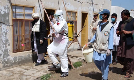 Afghan health workers spray disinfectants at public places in Helmand, Afghanistan, in April.