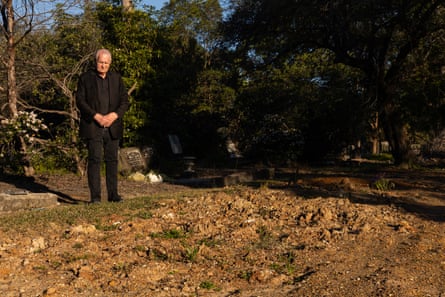 Reverend Bill Crews at the site of an unmarked grave plot