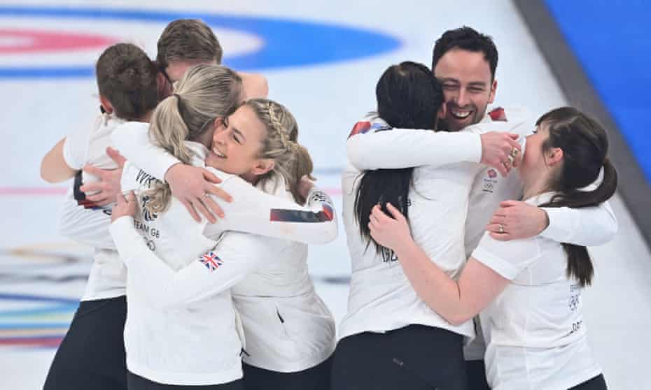 Great Britain’s women’s and men’s curlers celebrate Eve Muirhead and her team’s gold medal at the Winter Olympics in Beijing