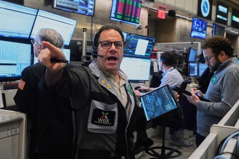 Options trader Anthony Spina points while shouting on the New York Stock Exchange floor