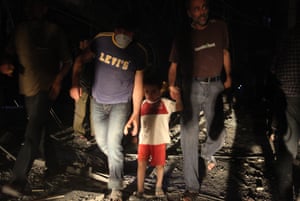 People leaving the Salah al-Din area in Aleppo after it was hit by airstrikes