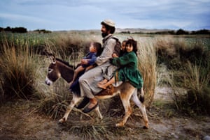 Family rides a donkey, Maimana, Afghanistan, 2003
