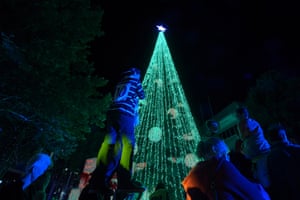 People gather to look at the tree which was attempting to beat the Guinness World Record for most lights on a tree in Canberra, Australia. The 22 metre tree had over half a million lights