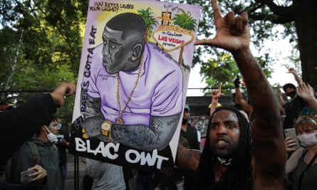 A person holds a banner during a protest over the death of George Floyd in Washington on Tuesday.