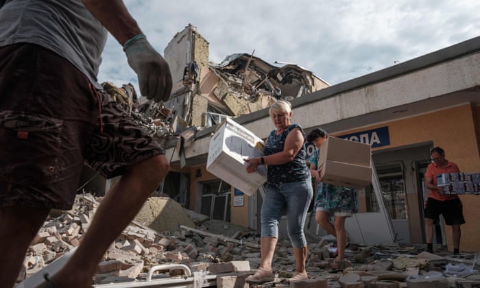 Teachers and workers carry out surviving items from their school destroyed as a result of a shelling in Bakhmut, Donetsk region.