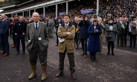 Racegoers in the stand watch the action at the Cheltenham Festival