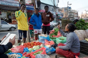 From left to right: Djibril Kabore from Burkina Faso, Fidele Keriane from Ivory Coast and Kande Sidibe from Mali shop for vegetables on the southern outskirts of Kathmandu, Nepal.