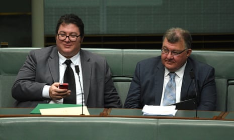 Government backbenchers George Christensen and Craig Kelly seated side by side in the House of Representatives.