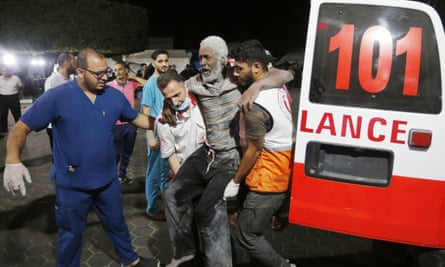 Survivors of a blast at the al-Maghazi refugee camp in central Gaza are brought to al-Aqsa Martyrs Hospital