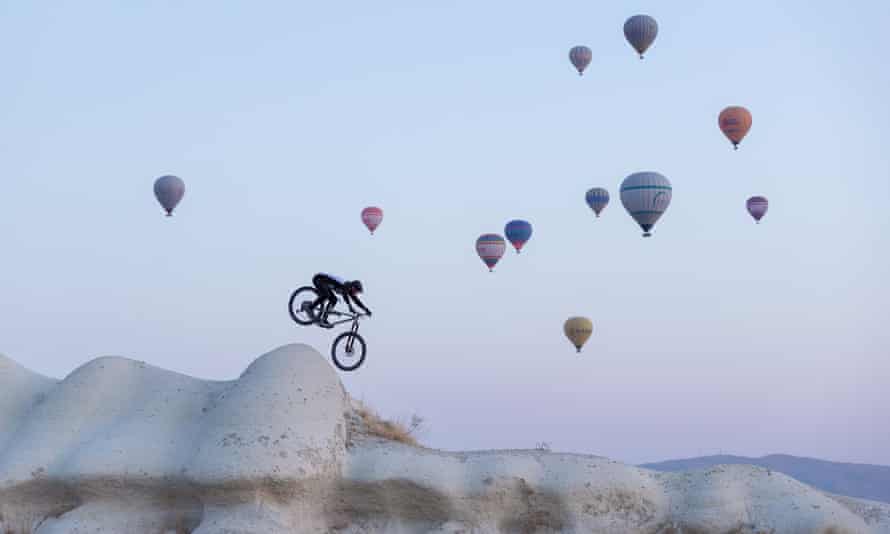 Killion Bron rides the fairy chimneys of Cappadocia under a cloud of hot air balloons