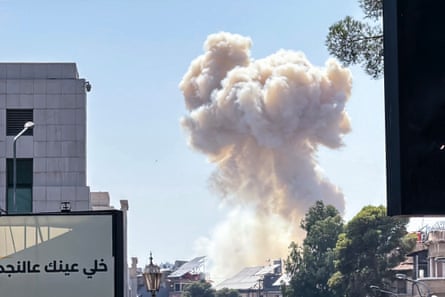 Smoke billows above buildings
