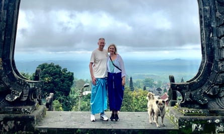 Lianne and Grant Francis posing against a blue sky near Balinese-style monuments