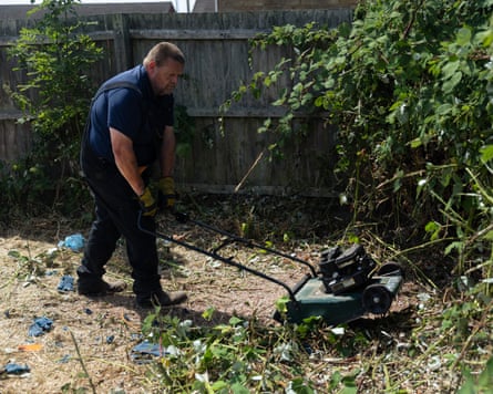 He runs a lawnmower over a pile of garden waste