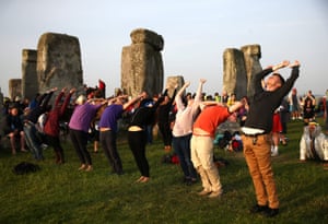 Amesbury, England People practice yoga at Stonehenge