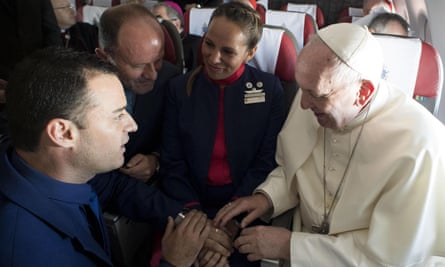 Pope Francis conducts the wedding ceremony at the front of the plane