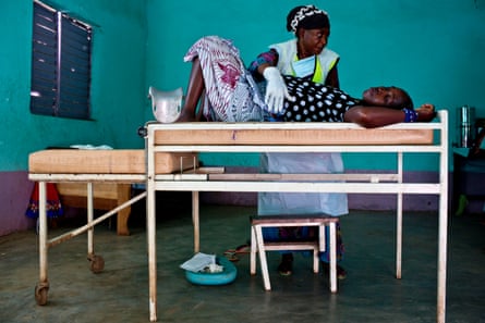 A woman is examined by a midwife at a health clinic near Doko, Siguiri, Guinea.