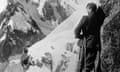 A black and white image of George Mallory on the right standing on a mountainside