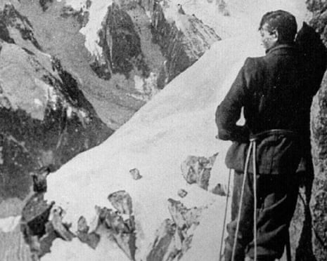 A black and white image of George Mallory on the right standing on a mountainside