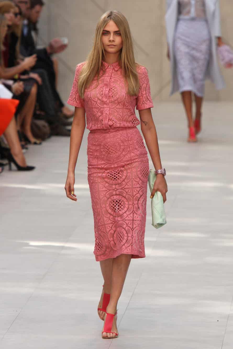 Cara Delevingne walks the runway at the Burberry Prorsum show during London fashion week in September 2013.
