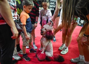Children stand around a poodle called Joline